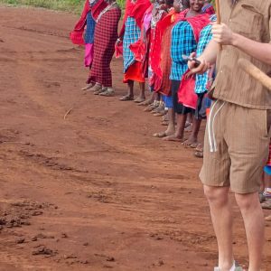 Johari Africa Adventures guests dancing with Maasai warriors Masai Mara book the best Kenya luxury safari tour packages from Nairobi Diani Mombasa Malindi and Watamu
