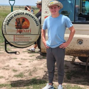 Johari Africa Adventures safari guide beside 4x4 jeep - book the best Kenya luxury safari tour packages from Nairobi, Diani, Mombasa, Malindi and Watamu - www.johariafricaadventures.com